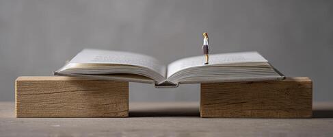 The open book with a miniature figure representing exploration and imagination. photo