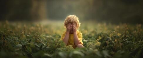 The child expressing emotions in a tranquil field setting during sunset. photo