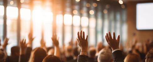 The audience raising hands for engagement during a business seminar. photo
