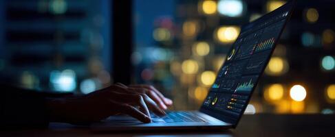 The laptop displaying data analytics in a dimly lit urban setting. photo