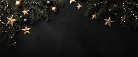 The elegant Christmas arrangement of pine branches and golden stars on black background photo