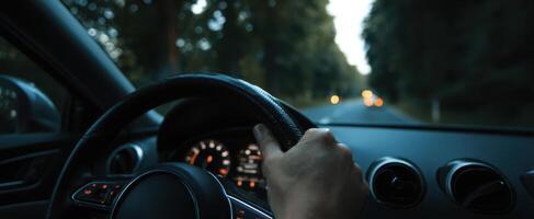 The Hand Gripping a Steering Wheel on a Serene Night Drive photo