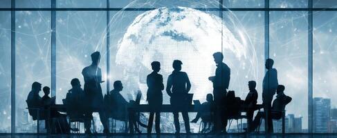 The business meeting with silhouettes against a digital globe backdrop. photo