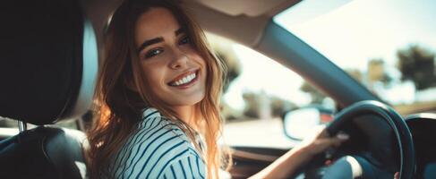 The young woman smiling joyfully while driving her car on a sunny day photo