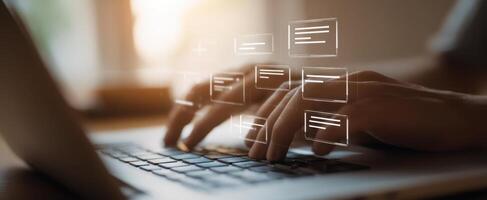 The hands interacting with a laptop display and emerging digital interface elements. photo