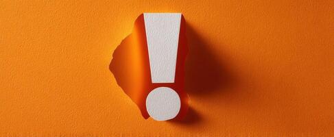 The Exclamation Mark on an Orange Background Emphasizing Attention and Importance photo