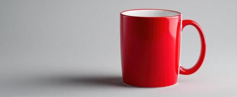 The vibrant red mug on a smooth gray background showcasing modern design. photo