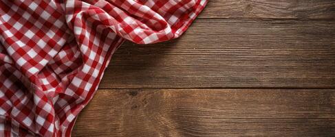 The checkered tablecloth adding rustic charm to a wooden surface. photo