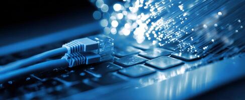 The connection of technology with fiber optic cables and a laptop keyboard photo