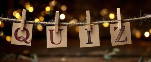 The Quiz Letters Displayed with Warm Bokeh Background and Clothespins photo
