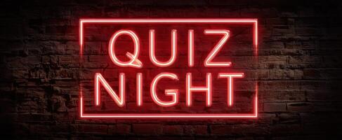 The vibrant neon sign announcing a fun and engaging quiz night event. photo