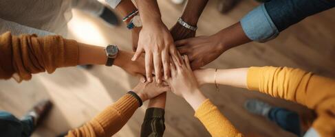 The collaborative hands symbolizing teamwork and unity in a diverse environment. photo
