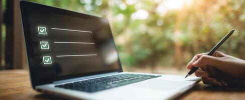 The laptop displaying a checklist in a serene outdoor workspace. photo