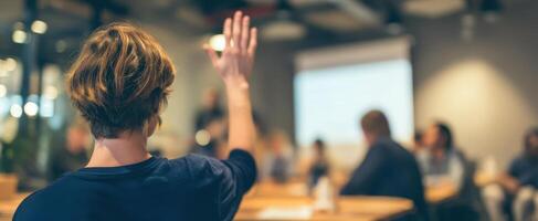 The participant raising hand during an engaging business seminar discussion. photo