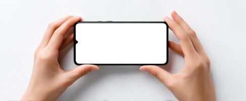 The smartphone held by hands with a blank screen for customizable content. photo