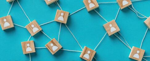 The network connection represented by wooden profile icons on a vibrant background. photo