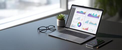 The laptop displaying colorful data and analytics charts in a modern workspace. photo
