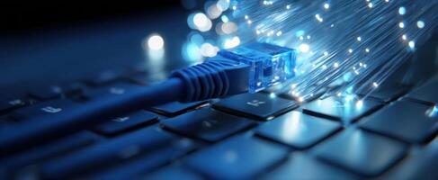 The glowing fiber optic cable connected to a modern computer keyboard. photo