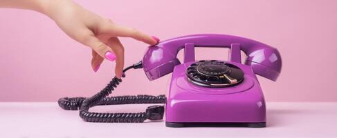 The vibrant purple rotary phone with a feminine touch and sleek design. photo