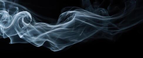 The graceful dance of smoke swirling in the air on a dark background. photo