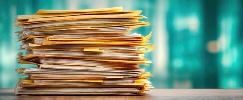 The cluttered stack of paperwork waiting for organization in an office setting. photo