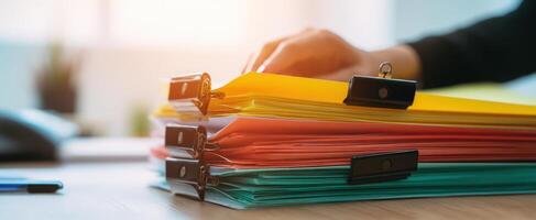 The vibrant collection of organized folders and documents on a clean desk. photo