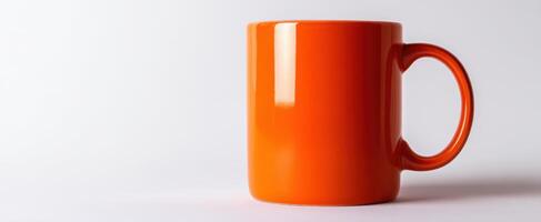 The bright orange mug shining elegantly against a minimalist background photo