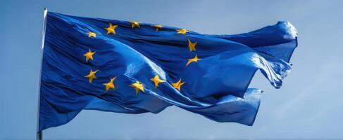 The European Union flag waving proudly against a clear blue sky. photo