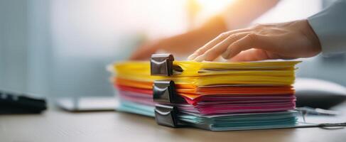 The organized stack of colorful documents ready for office workflow photo