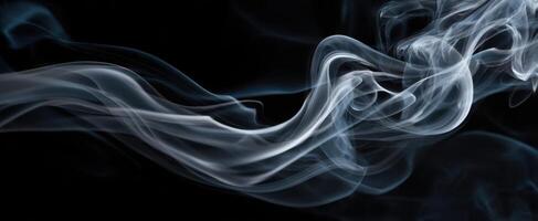 The ethereal beauty of smoke swirling gracefully against a dark background. photo