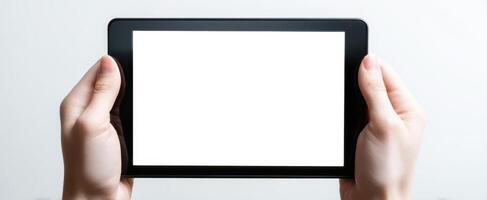 The tablet held in hands with a blank screen for design purposes. photo