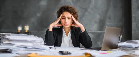 The overwhelmed woman surrounded by paperwork in a busy office environment. photo