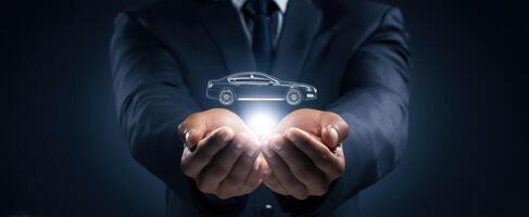 The businessman presenting a futuristic car concept in his hands. photo