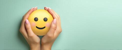 The Hands Holding a Smiling Emoji Symbolizing Joy and Positivity photo