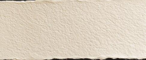 The textured surface of handmade paper with a torn edge for crafts. photo