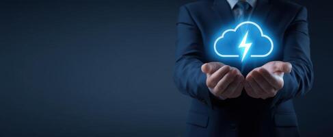 The businessman holding a glowing cloud icon with lightning symbolizing digital innovation. photo