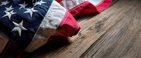 The American flag elegantly draped on rustic wooden background showcasing textures. photo