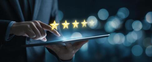 The business professional interacting with digital review stars on a tablet. photo