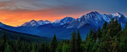 The majestic mountains under a vibrant sunset sky. photo
