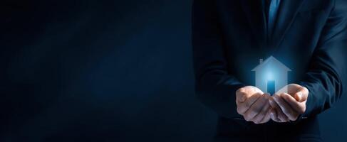 The Hands Holding a Digital House Icon Symbolizing Future Home Ownership photo