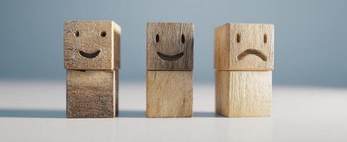 The wooden figurines illustrating emotions of happiness and sadness side by side. photo