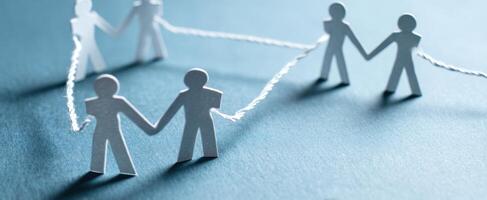 The Unity of Paper Figures Connected by String Symbolizing Collaboration and Support photo