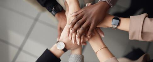 The collaborative hands representing unity and teamwork in a professional setting. photo