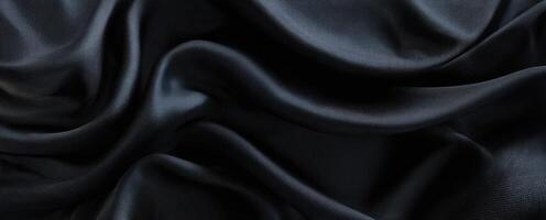 The smooth black silk fabric creating elegant folds and captivating texture. photo