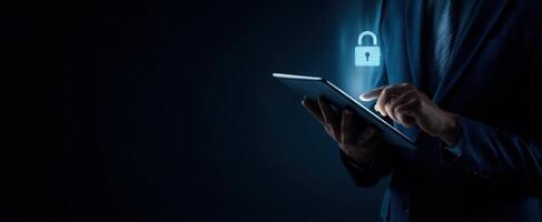 The businessman interacting with a secure tablet displaying digital lock symbol. photo