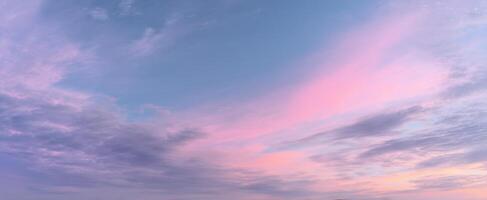 The stunning pastel sky filled with clouds at sunset. photo