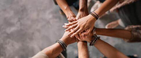 The hands of friends joining together in celebration of unity and teamwork. photo