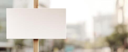 The blank wooden sign ready for creative messages in an urban background. photo