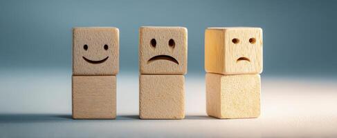 The emotional journey represented by wooden blocks showcasing different expressions. photo