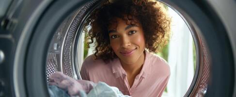 The woman smiling from inside a washing machine with vibrant domestic atmosphere. photo